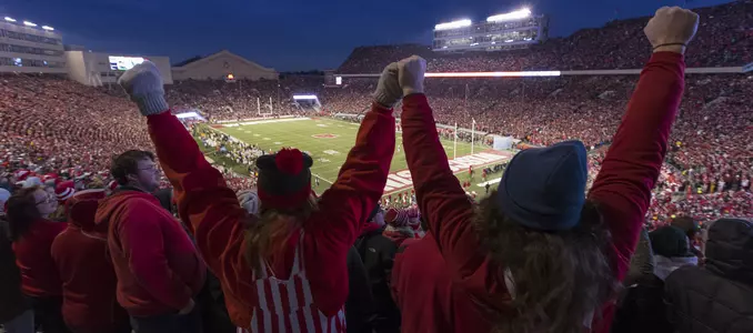 Students cheering with arms raised in Camp Randall Stadium for football game vs. Iowa 2017