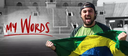 Beautiful Game headline image Rafael Gaglianone holding Brazilian flag inside Camp Randall Stadium