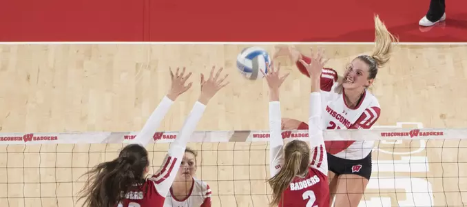 Grace Loberg attacks the ball against Dana Rettke and Sydney Hilley