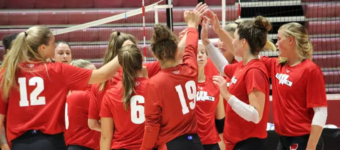 The Badger volleyball team huddles up on the court during practice.