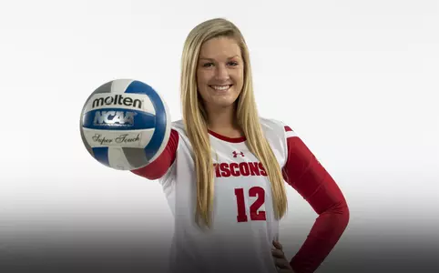 Nicole Shanahan holds a volleyball against a white background
