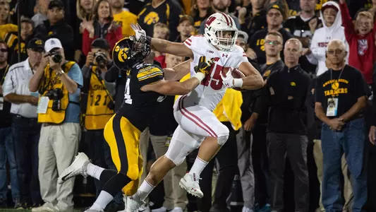 Alec Ingold stiff arms an Iowa defender during football game at Iowa 2018