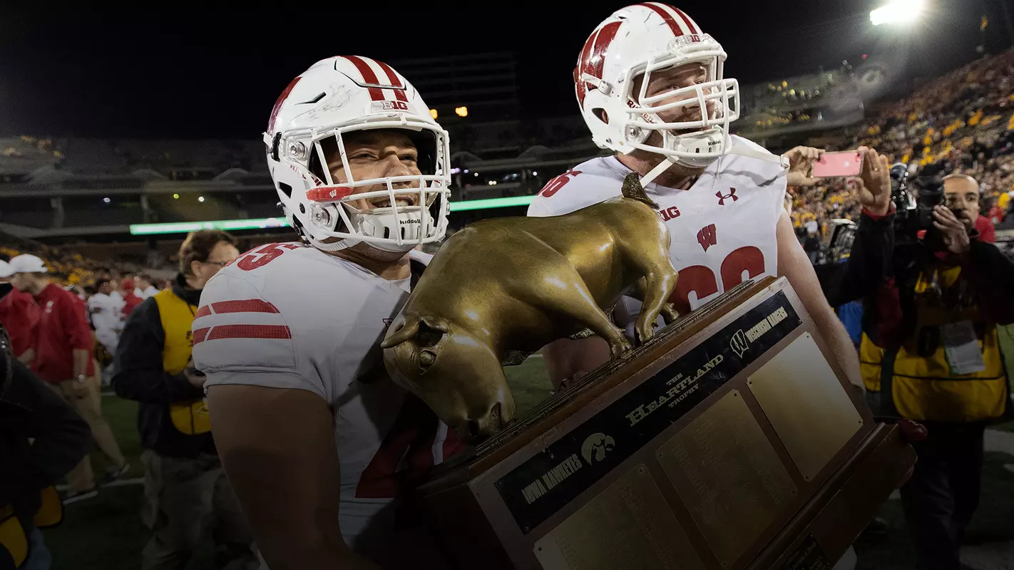 Alec Ingold and Beau Benzschawel celebrate UW's 28-17 win over Iowa with the Heartland Trophy