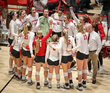Volleyball team cheers in a circle by the side of the court during match vs. Texas at the UW Field House 2018