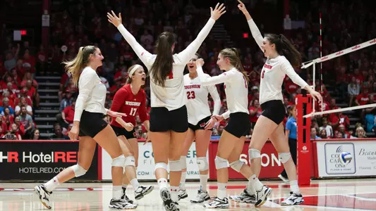 The Badgers celebrate a point on the court.