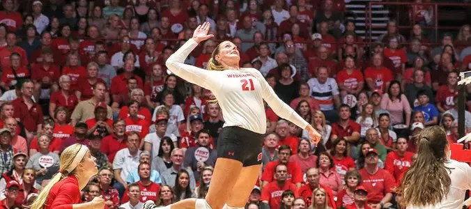 Grace Loberg attacks the ball against two Texas blockers