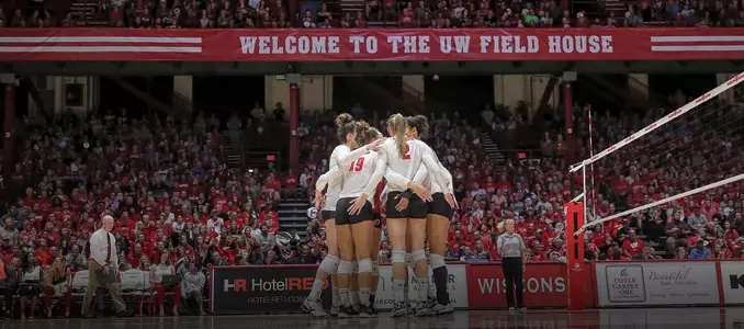 The Badgers huddle up on the court during a match