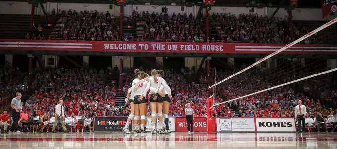 The Badgers huddle up on the court during a match