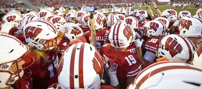 Wisconsin Badgers teammates huddle prior to an NCAA college football game against the Western Kentucky Hilltoppers Friday, August 31, 2018, in Madison, Wisconsin. The Badgers won 34-3. (Photo by David Stluka)