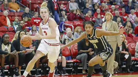 Kelly Karlis dribbles past a Purdue defender.