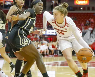 Kendra Van Leeuwen dribbles around a Purdue defender