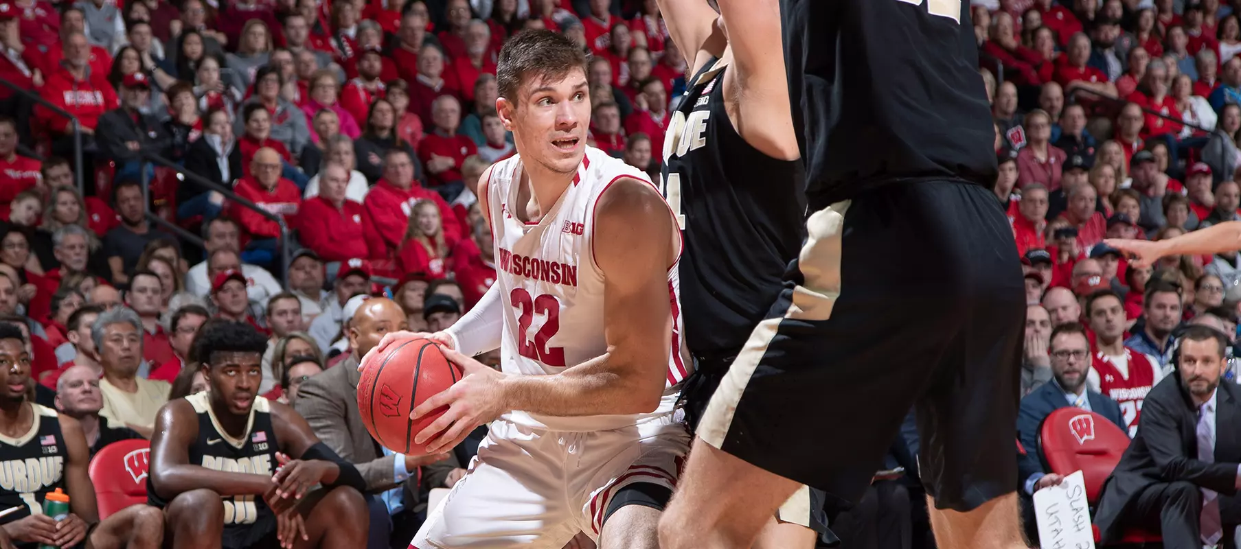 Ethan Happ looks to pass out of a double team during a game against Purdue