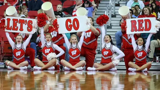 Cheerleders with the signs let's go red