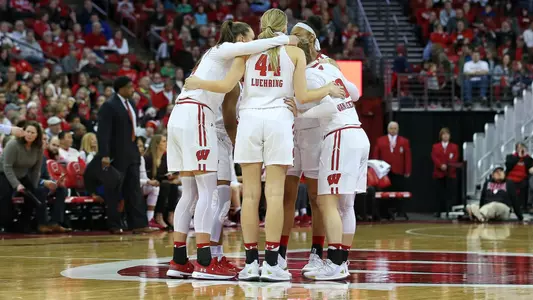The Badgers huddle up on the court.
