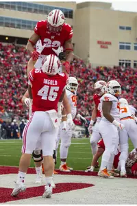 Alec Ingold lifts up Jonathan Taylor in celebration during football game vs. Illinois 2018 at Camp Randall Stadium