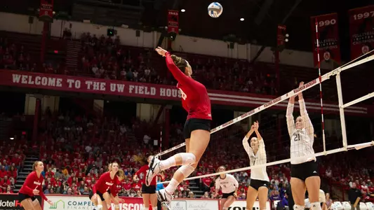 Molly Haggerty hits the ball against a Purdue blocker.