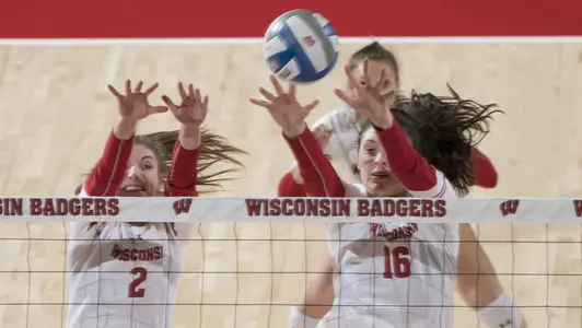 Sydney Hilley and Dana Rettke block a Minnesota shot