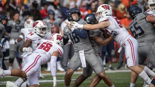 Wisconsin Badgers defense - Chris Orr (54), Zack Baun (56) and Jack Sanborn (57) - swarms Illinois' quarterback during an NCAA Big Ten Conference college football game against the Illinois Fighting Illini Saturday, Oct. 19, 2019, in Champaign, Ill. (Photo by David Stluka/Wisconsin Athletic Communications)
