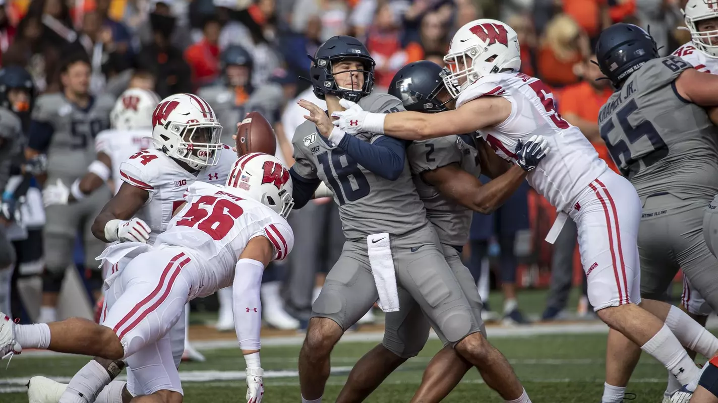 Wisconsin Badgers defense - Chris Orr (54), Zack Baun (56) and Jack Sanborn (57) - swarms Illinois' quarterback during an NCAA Big Ten Conference college football game against the Illinois Fighting Illini Saturday, Oct. 19, 2019, in Champaign, Ill. (Photo by David Stluka/Wisconsin Athletic Communications)