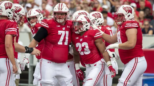 Wisconsin Badgers running back Jonathan Taylor (23) celebrates a touchdown with offensive line Cole Van Lanen, teammates during an NCAA college football game against Central Michigan Chippewas Saturday, Aug. 7, 2019, in Madison, Wis. The Badgers won 61-0. (Photo by David Stluka/Wisconsin Athletic Communications)