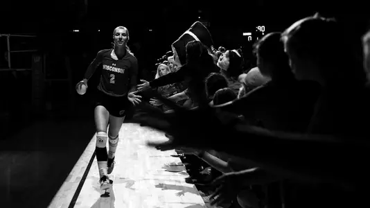 Sydney Hilley slaps the hands of the children during the announcement of the starting lineup.