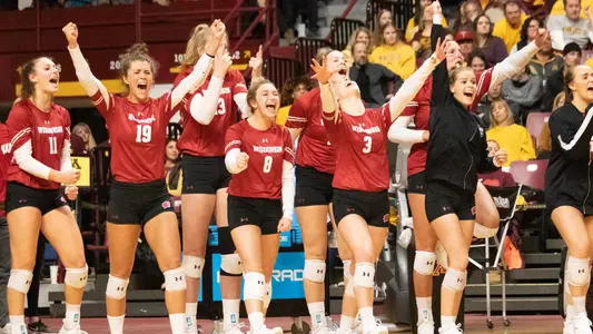 Badgers bench celebrates a point at Minnesota
