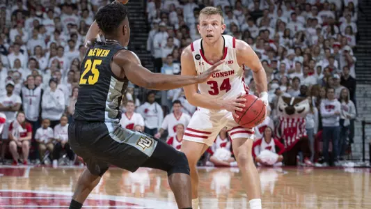 Wisconsin Badgers guard Brad Davison (34) handles the ball during an NCAA college basketball game against the Marquette Golden Eagles Sunday, Nov. 17, 2019, in Madison, Wis. The Badgers won 77-61. (Photo by David Stluka/Wisconsin Athletic Communications)