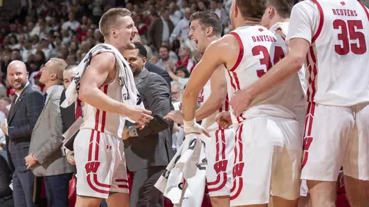 Wisconsin Badgers Guard Brevn Pritzl (1) celebrates with teammates during an NCAA college basketball game against the Marquette Golden Eagles Sunday, Nov. 17, 2019, in Madison, Wis. The Badgers won 77-61. (Photo by David Stluka/Wisconsin Athletic Communications)