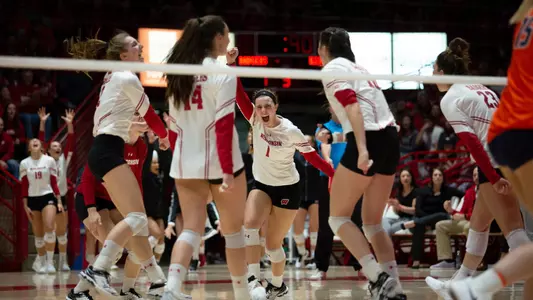 The Badgers celebrate a point on the court against Illinois.