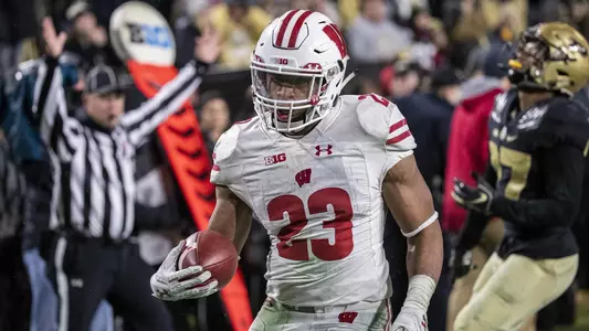 Wisconsin Badgers running back Jonathan Taylor (23) scores a touchdown in overtime during an NCAA Big Ten Conference college football game against the Purdue Boilermakers Saturday, November 17, 2018, in West Lafayette, Indiana. The Badgers won in triple overtime 47-44. (Photo by David Stluka)