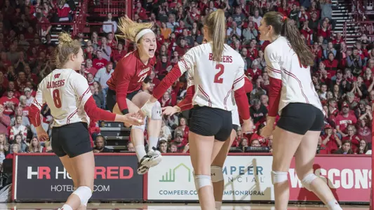 The Badgers celebrate a point on the court against Michigan State.