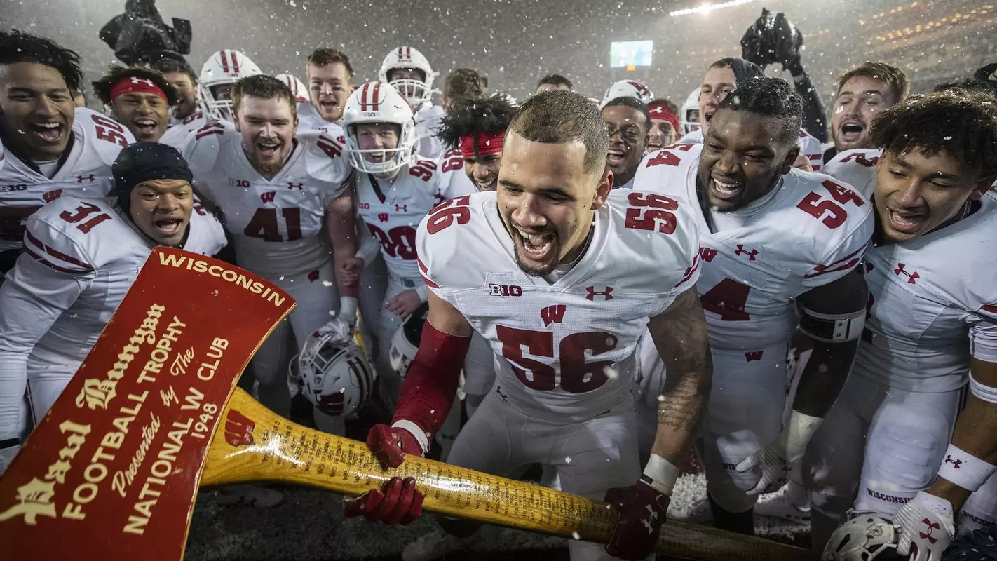Wisconsin Badgers Zack Baun amd teammates chop down the goalpost with Paul Bunyan's Axe to celebrate winning an NCAA Big Ten Conference college football game against the Minnesota Golden Gophers Saturday, Nov. 30, 2019, in Minneapolis. The Badgers 38-17. (Photo by David Stluka/Wisconsin Athletic Communications)