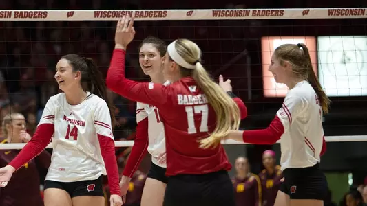 The Badgers celebrate a point on the court against Minnesota