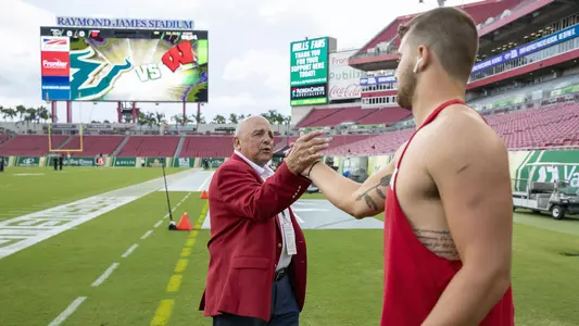 Wisconsin Badgers Athletic Director Barry Alvarez greets his grandson Jake Ferguson (84) prior to an NCAA college football game against the USF Bulls Saturday, Sept. 30, 2019, in Tampa Bay, Florida. The Badgers won 49-0. (Photo by David Stluka/Wisconsin Athletic Communications)