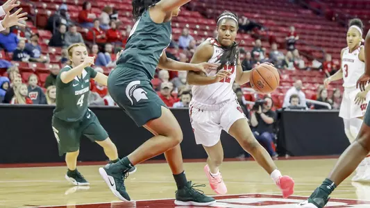 Niya Beverley drives the lane past a Michigan State defender.