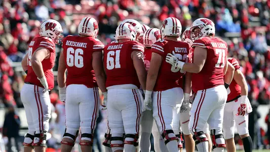 Wisconsin offensive linemen huddle together during a football game against Illinois at Camp Randall 2018