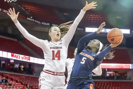Abby Laszewski blocks a shot from an Illinois player.