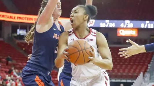 Imani Lewis drives to the basket against an Illinois defender