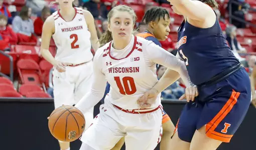 Kendra Van Leeuwen drives to the basket against an Illinois defender