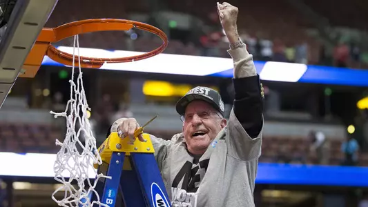 Wisconsin Badgers Otto Puls cuts down a piece of the net after the Western Regional Final NCAA college basketball tournament game against the Arizona Wildcats Saturday, March 29, 2014 in Anaheim, California. The Badgers won 64-63 (OT). (Photo by David Stluka)