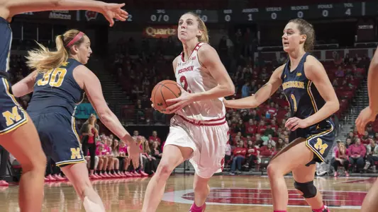 Kelly Karlis drives the lane against Michigan