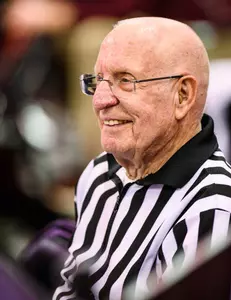 Long-time referee and scorekeeper Otto Puls officiates a game as the Wisconsin men's basketball team plays the Minnesota Gophers at the Kohl Center at the University of Wisconsin Madison on Jan. 3, 2019. (Photo by Jeff Miller / UW-Madison)