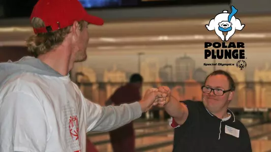 Badgers Give Back Special Olympics - UW student-athlete fist bumps with Special Olympics athlete at bowling event. Photo has logo of Polar Plunge included.