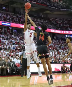 Aleem Ford shooting basketball over Maryland player during men's basketball game at Kohl Center 2019