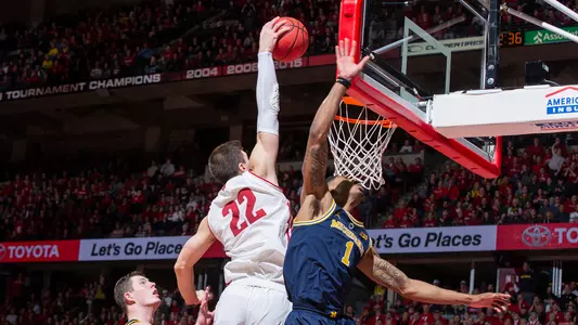 Ethan Happ rises up for a dunk against Michigan