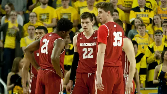 Badgers huddle during a game at Michigan