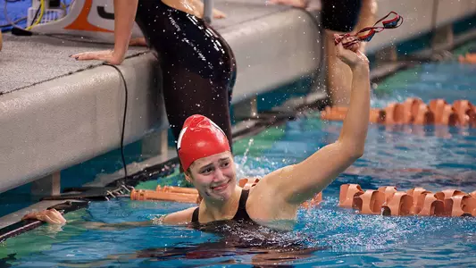 Beata Nelson waves to her family and fans after setting the American record in the 100 back at the 2018 Texas Invitational