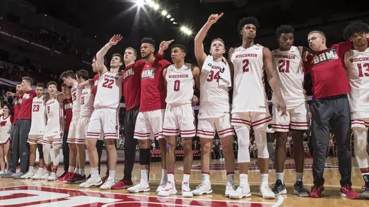 Men's basketball sings Varsity together after a game at the Kohl Center