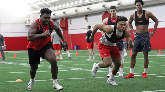 Chris Orr and Jonathan Taylor sprint at football winter conditioning practice 2019