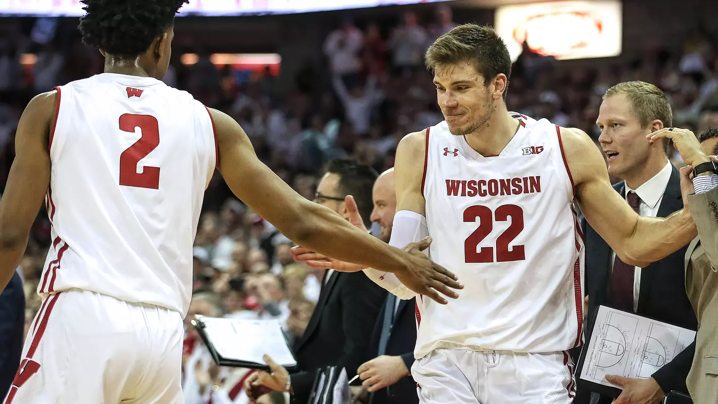 Ethan Happ high-fives Aleem Ford after a win